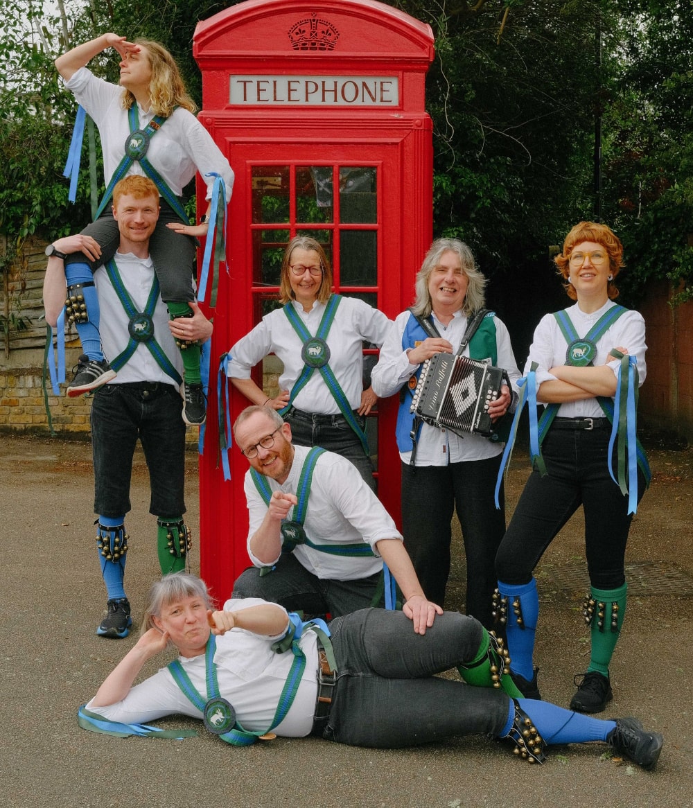 Two Quaggy Morris members with a person disguised as a pigeon